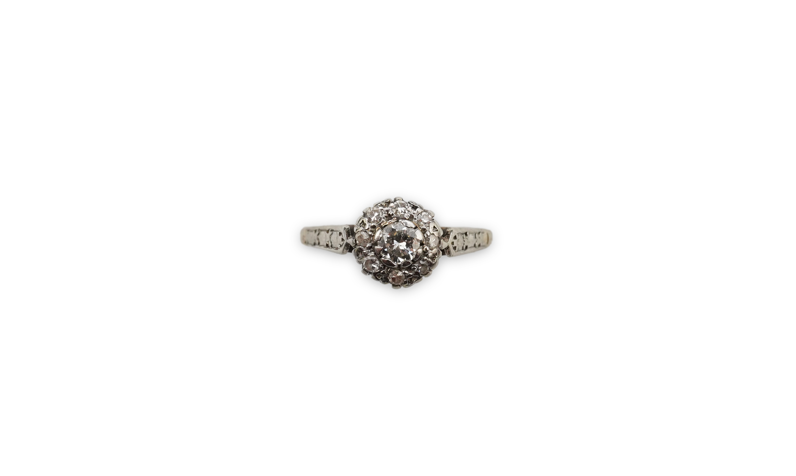 A diamond cluster ring, mid 20th century, set with a cluster of brilliant-cut diamonds totalling approximately 0.30 carats, mounted in unmarked white metal, size G, gross weight approximately 3 grams